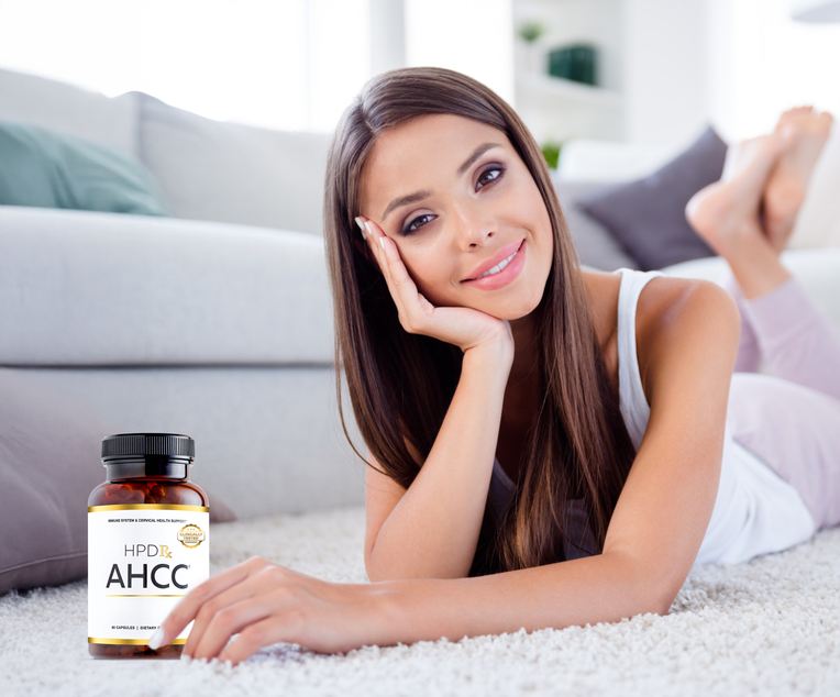 Woman with a bottle of HPD AHCC supplements in front of her.